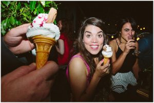 wedding guests laugh and eat ice cream